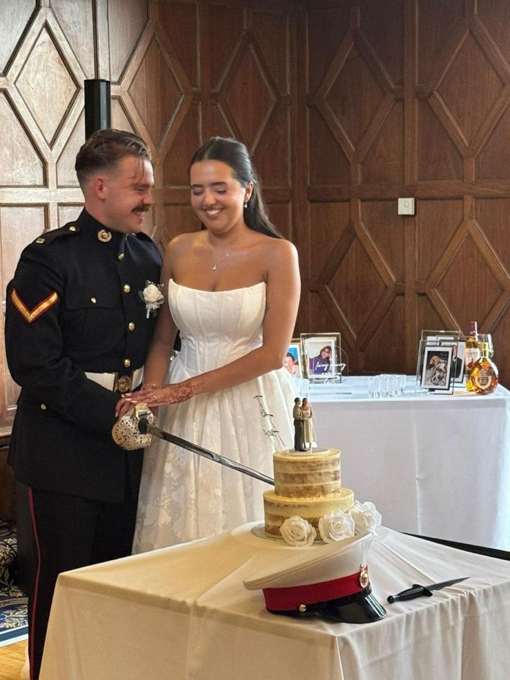 Bride and groom cutting their wedding cake